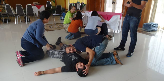 Participants practice first aid skills